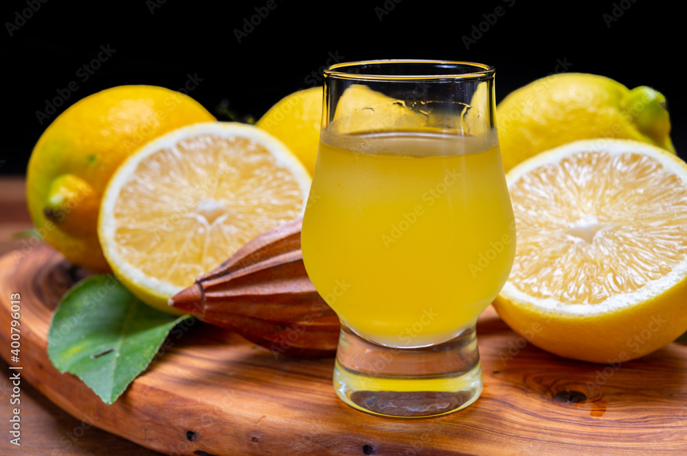 Ice cold sweet limoncello liqueur made from new harvest of fresh ripe yellow Italian lemons, Amalfi coast, Italy Ice cold sweet limoncello liqueur made from new harvest of fresh ripe yellow Italian lemons, Amalfi coast, Italy
