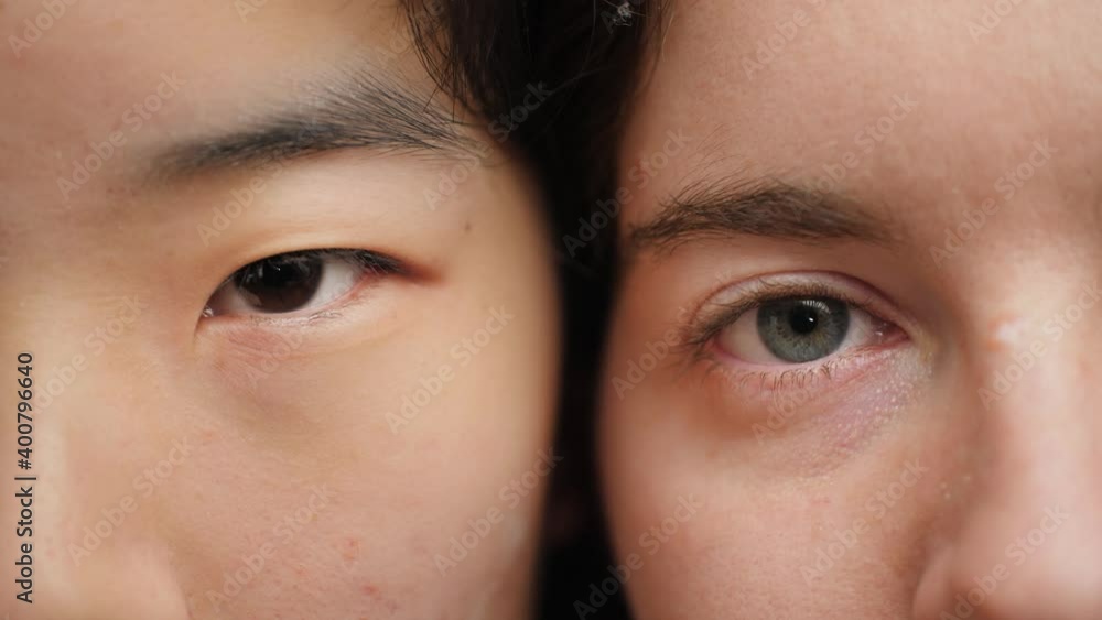 Eyes of a young Asian and Caucasian woman side by side looking at