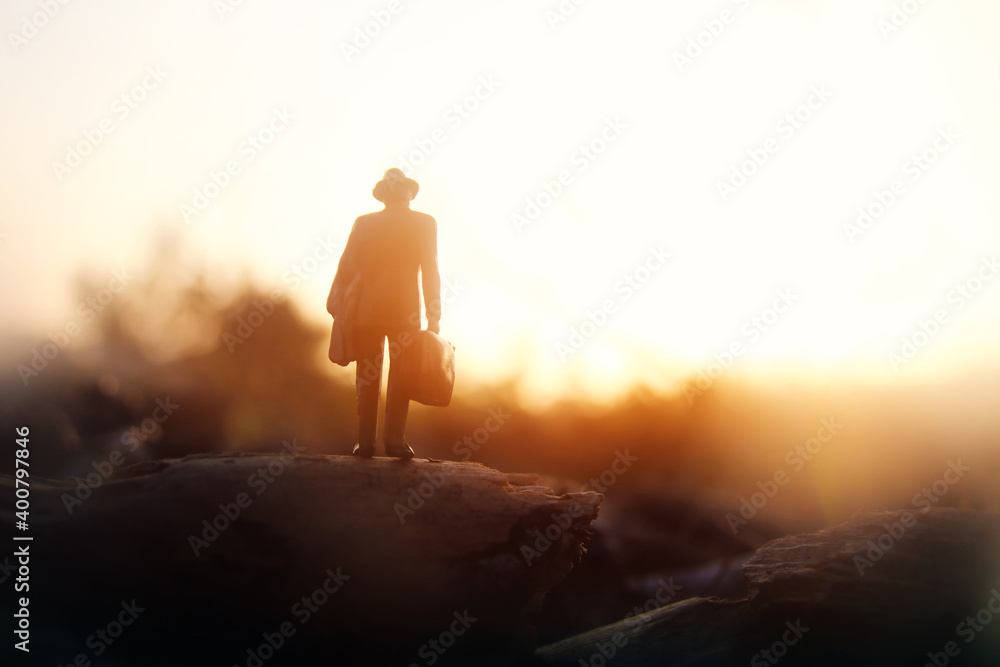 Surreal image of mysterious man walking alone during sunset Surreal image of mysterious man walking alone during sunset