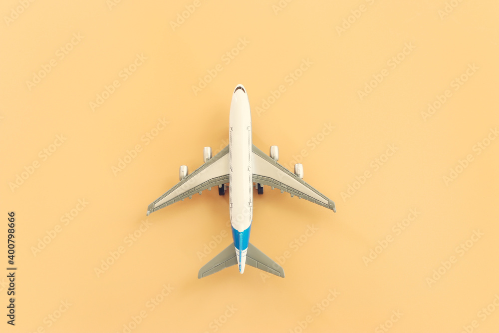 top view photo of airplane over pastel yellow background top view photo of airplane over pastel yellow background