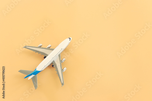 top view photo of airplane over pastel yellow background