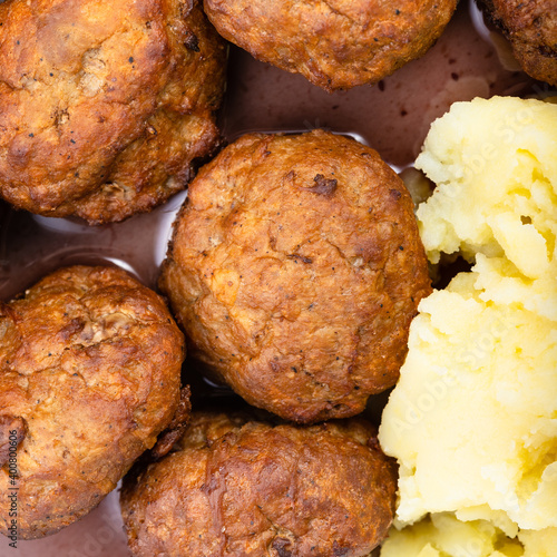 top view of cooked swedish meatballs with lingonberry sauce and mashed potatoes close up