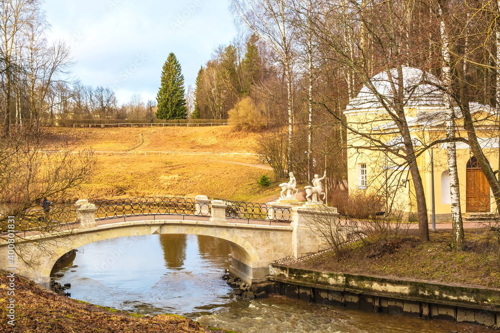 Bridge with centaurs over the Slavyanka river in the spring Pavlovsky park