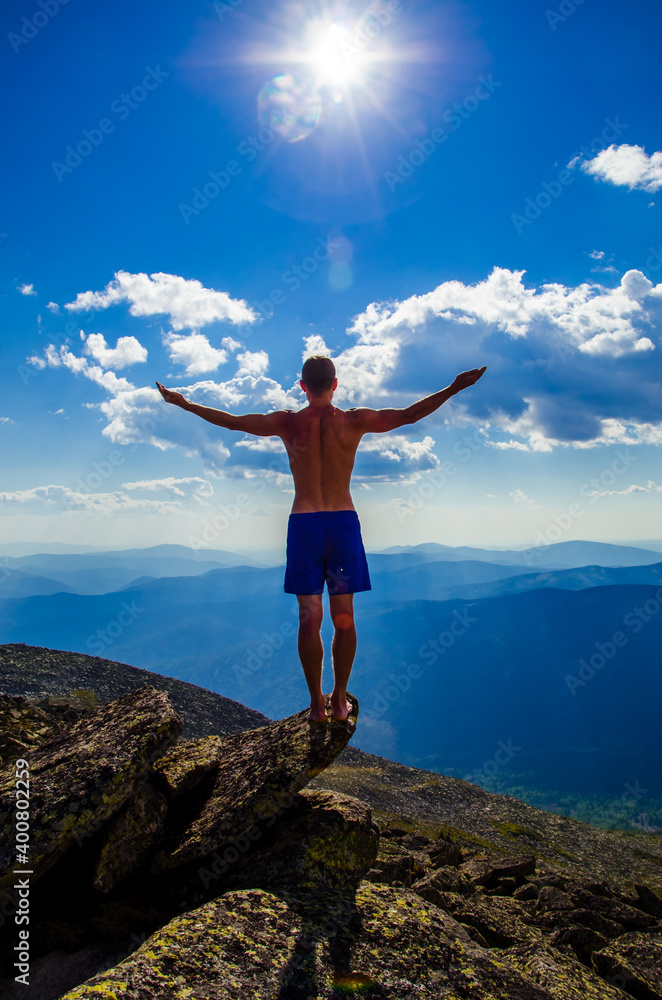 man stands on top of a mountain with open hand man stands on top of a mountain with open hand
