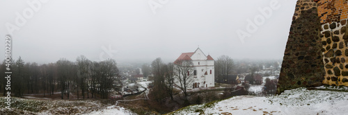 Panorama of tower Shchitovka and the church tower. Ruins of Mindovg Castle on Castle Hill. Farnese Church of Transfiguration of the Lord in the background. Novogrudok. Belarus. Travel concept. photo