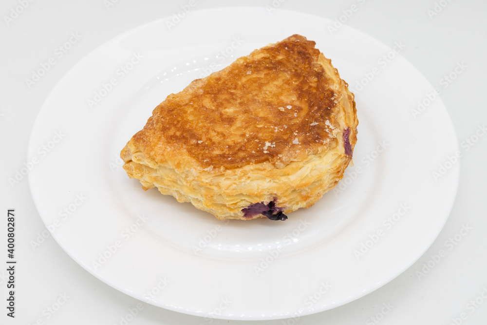 Blueberry Turnover on a White Plate with a White Background Blueberry Turnover on a White Plate with a White Background