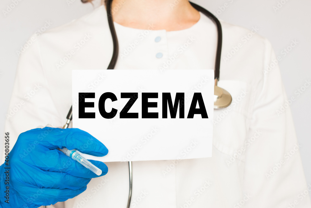 The doctor's blue - gloved hands show the word ECZEMA - . a gloved hand on a white background. Medical concept. the medicine The doctor's blue - gloved hands show the word ECZEMA - . a gloved hand on a white background. Medical concept. the medicine