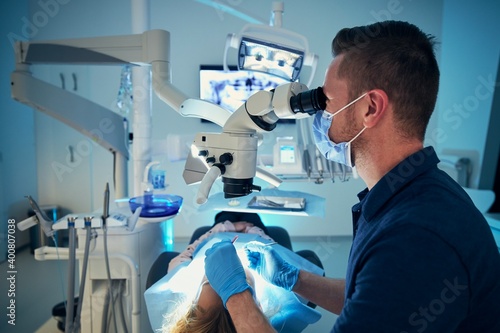 Dentist examining patient in modern dental surgery