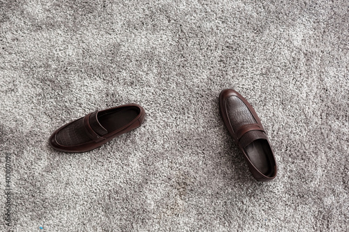 Classic male brown leather shoes on gray carpet background. groom s morning