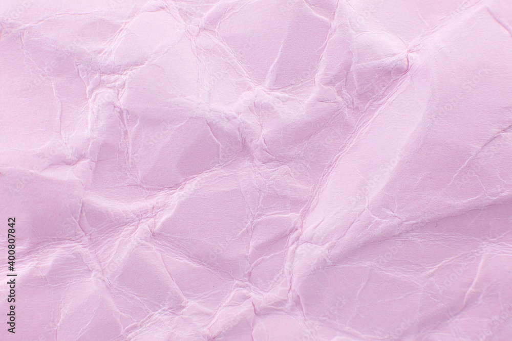 Fototapeta premium Crumpled pink paper background. Real macro battered texture. Close up photo.
