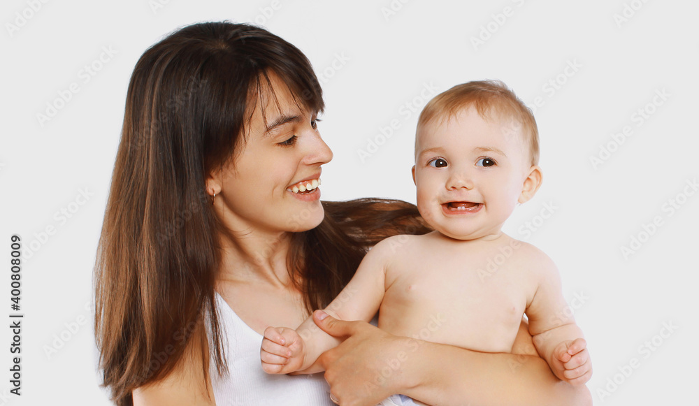 Portrait of cheerful smiling mother and baby playing together over a white background Portrait of cheerful smiling mother and baby playing together over a white background