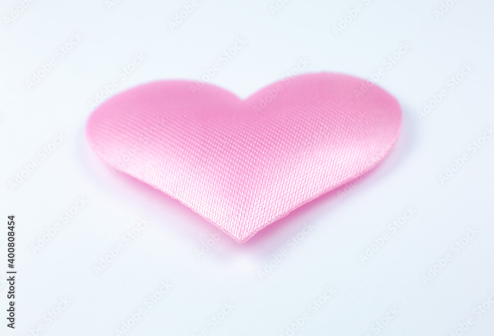 Fototapeta premium Pink heart on white background. Saint Valentine's day concept. Love and romantic photo. Postcard for holiday. Beautiful warm wallpaper with love. Soft focus. Copy space.