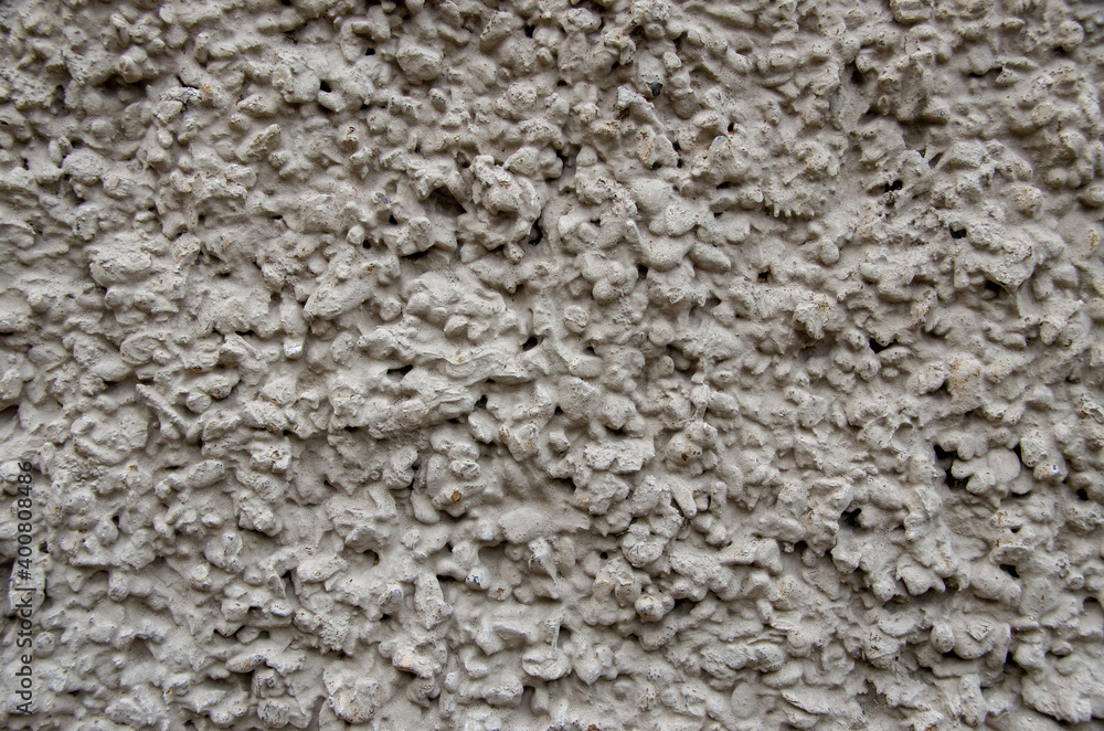 rough plaster facade painted gray as a texture or background. High quality photo rough plaster facade painted gray as a texture or background. High quality photo