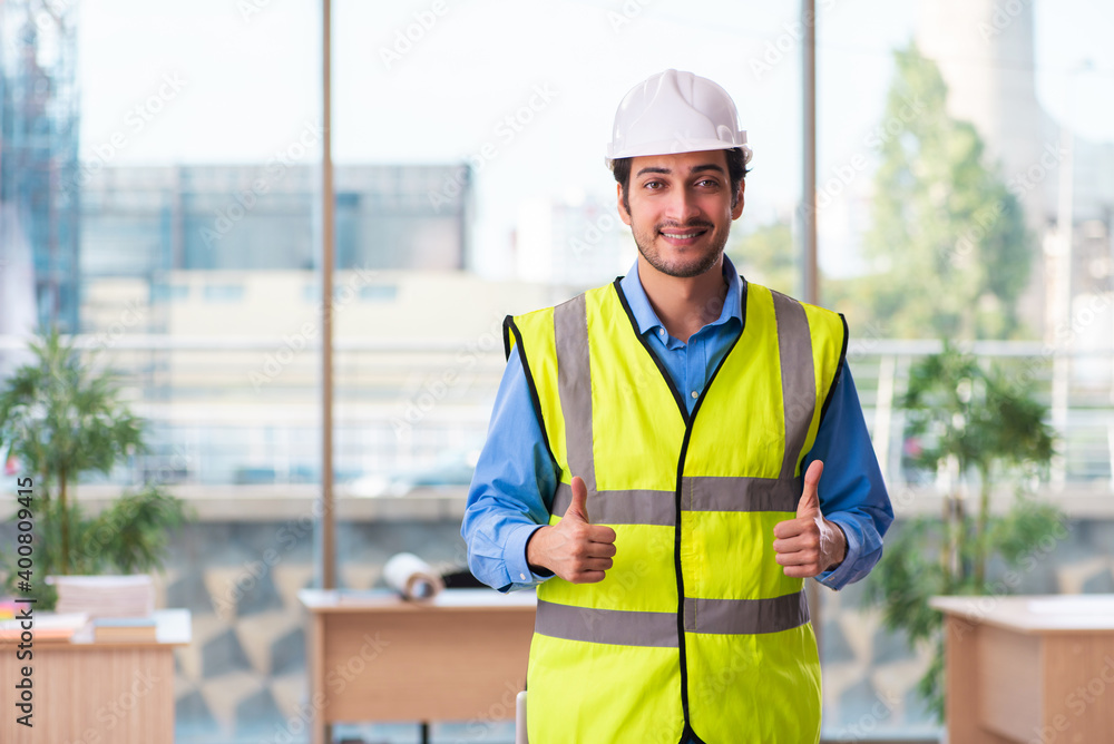Young male architect working in the office Young male architect working in the office