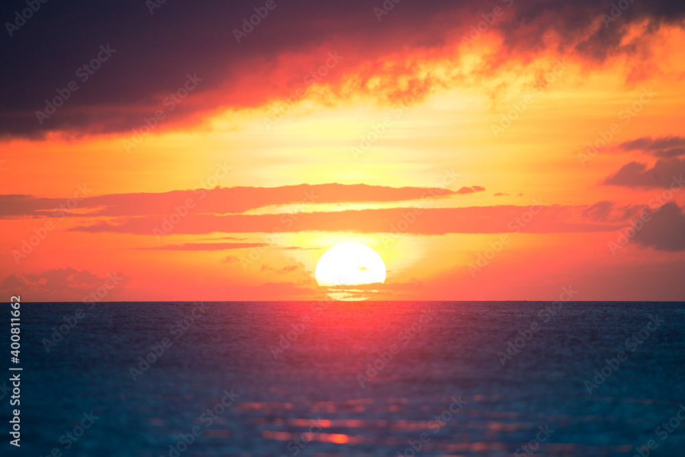 Colorful sunset of a huge sun in the sea