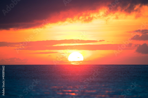 Fototapeta Naklejka Na Ścianę i Meble -  Colorful sunset of a huge sun in the sea