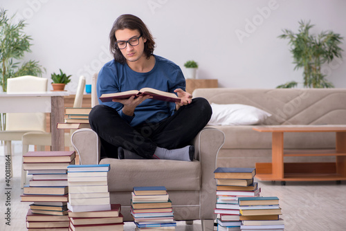 Young male student preparing for exams at home