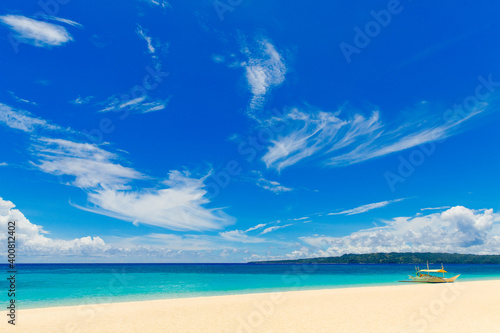 Fototapeta Naklejka Na Ścianę i Meble -  Beautiful sky with clouds under tropical beach on Boracay island, Philippines. Sea, sailboat and white sand. Nature view. Summer vacation concept.