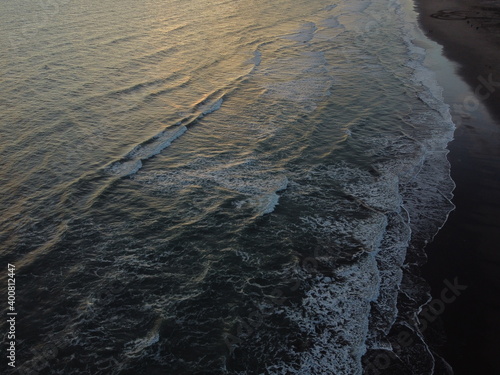 Sunset on Atlantic ocean Argentine coasts, brown sand and blue waves, picture with a drone. Monte Hermoso, Argentina photo