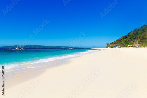 Tropical beach and beautiful sea with boats. Blue sky with clouds in the background. © frolova_elena