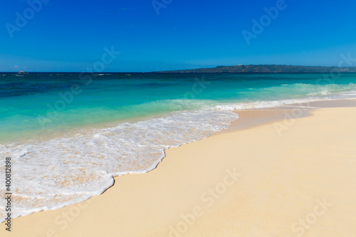 Tropical sandy seashore with blue wave on the Boracay island Philippines. Beach top view overhead seaside.