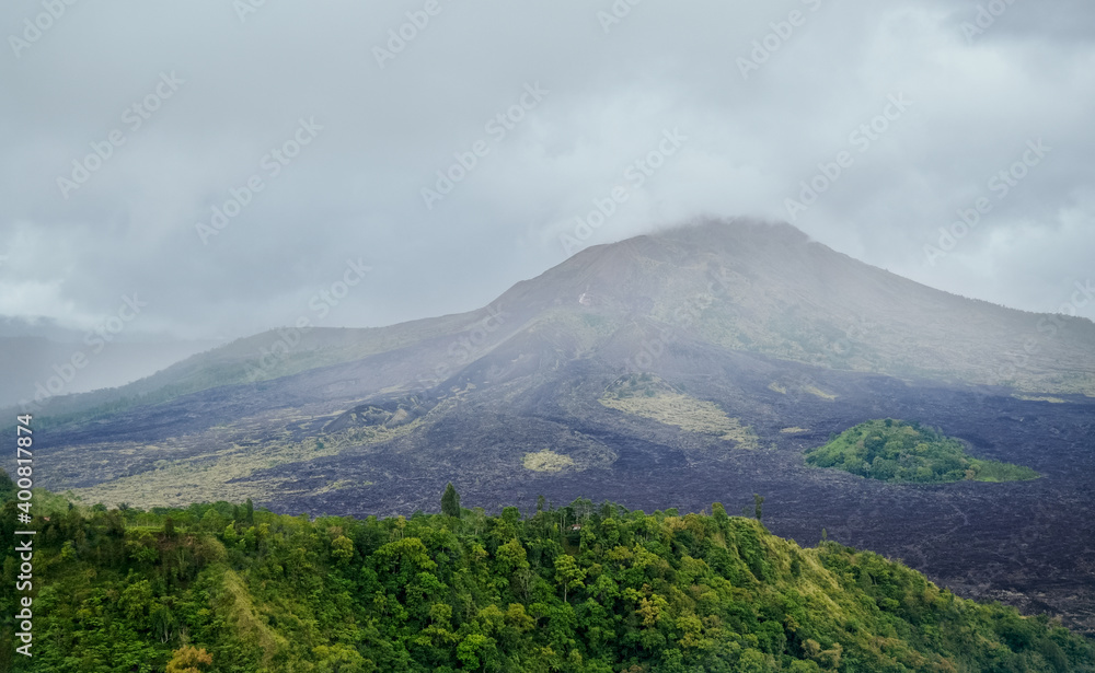 Gunung Batur is active volcano in the tropical island of Bali. The height of the volcano is 1717 meters
