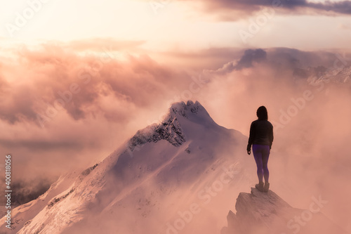 Fantasy Adventure Composite with a Girl on top of a Mountain Cliff with Dramatic Landscape in Background. Landscape from British Columbia, Canada. Dramatic Stormy Sunset Sky. © edb3_16