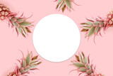 Frame made of pink pineapples. Trendy summertime concept with copyspace.
