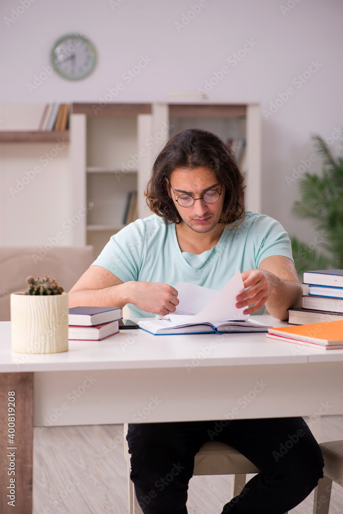Young male student preparing for exams at home Young male student preparing for exams at home