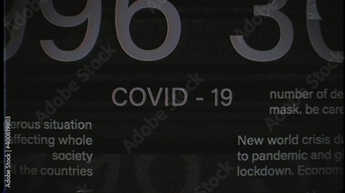 COVID-19 sign in the middle. Dynamic blinking Global outbreak information reports, world news, titles, keywords. Noise, vhs, glitch effects. International media concept. Coronavirus. 4K animation 