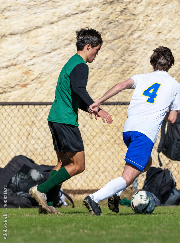 Young athletic boy competing in a soccer game Young athletic boy competing in a soccer game