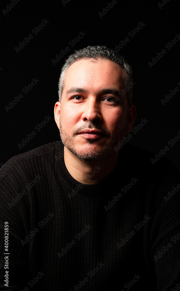 Fototapeta premium Portrair of a young man over a black background