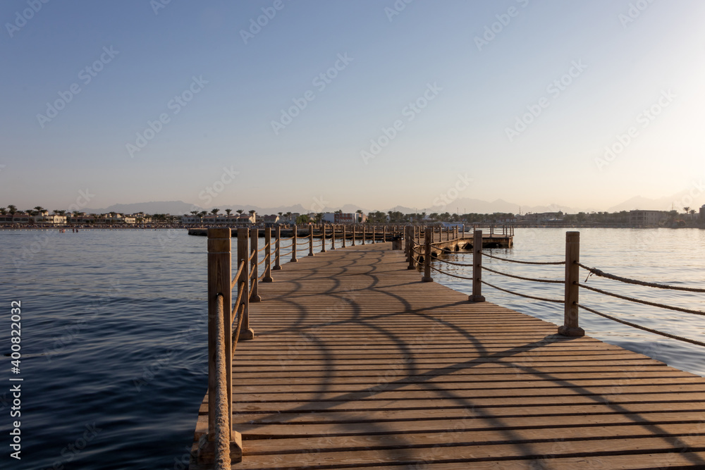 Fototapeta premium Hurghada, Egypt - September 28 2020: View of the wooden boardwalk over the Red Sea during sunset in Hurghada, Egypt