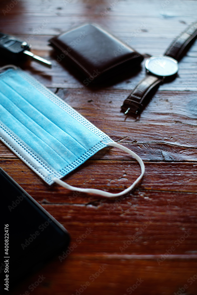 Surgical mask on table with man's objects Surgical mask on table with man's objects