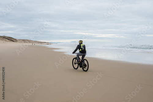 man doing electric fat bike on the beach