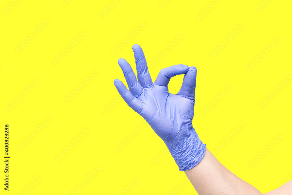 Hand in glove isolated on yellow background. Symbol OK. Everything is good. All right. Okey. Okay. Very good. A little bit. You're right. You are the best. Victory over the disease. Found a solution Hand in glove isolated on yellow background. Symbol OK. Everything is good. All right. Okey. Okay. Very good. A little bit. You're right. You are the best. Victory over the disease. Found a solution