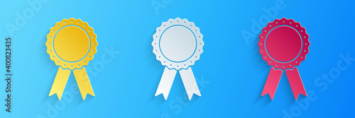 Paper cut Medal badge with ribbons icon isolated on blue background. Paper art style. Vector.