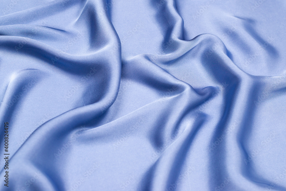 Obraz premium Blue silk or satin luxury fabric texture. Top view.