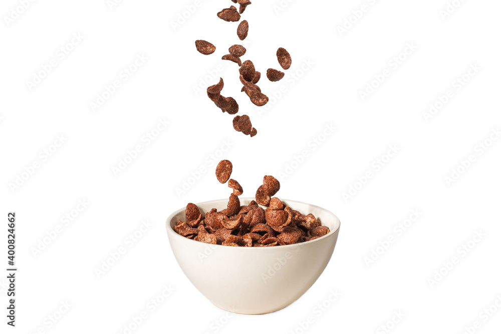 Chocolate corn flakes falling to the white bowl isolated on white. Motion. Chocolate corn flakes falling to the white bowl isolated on white. Motion.