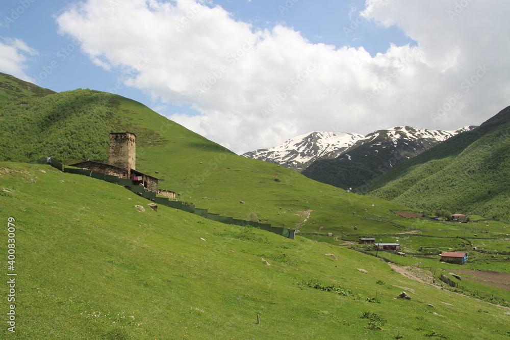 Snowy peaks of the mountans with green valleys, old village Ushguli in Svanetia