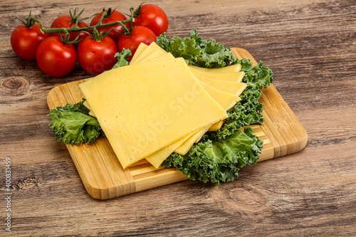Sliced Gauda cheese over board