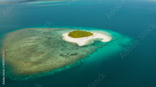 Sandy beach and tropical island by atoll with coral reef and axure water, top view. Patawan island with sandy beach. Summer and travel vacation concept. photo