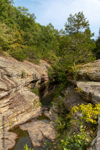Barren rock formations and small creek run between the trees in the Bell Smith Springs area of the Shawnee National Forest.