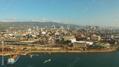 Aerial view of panorama of Cebu city with skyscraper, buildings and seaport with ships and ferries in the early morning. Philippines.