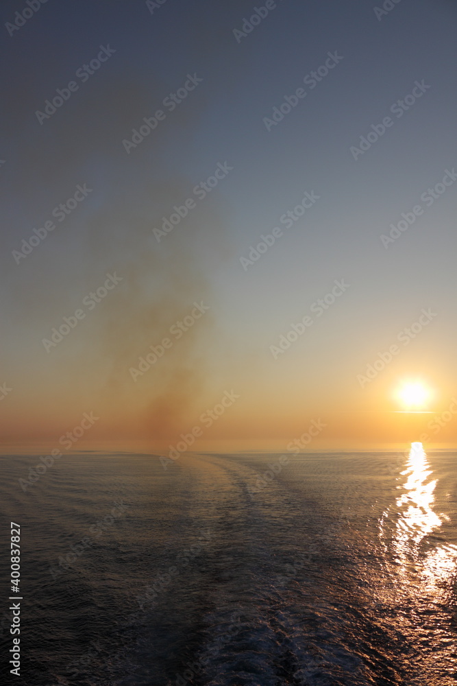 sunset over the sea with ferry smoke sunset over the sea with ferry smoke
