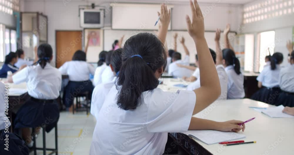 Slow motion of Asian high school students in white uniform actively study science by raising their hands to answer questions that teachers ask them in classroom. Slow motion of Asian high school students in white uniform actively study science by raising their hands to answer questions that teachers ask them in classroom.