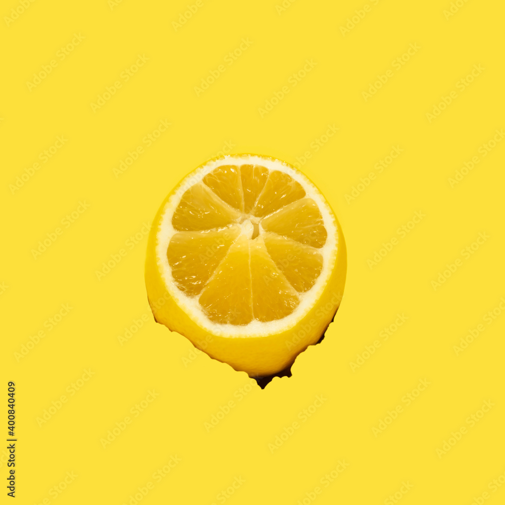 Torn hole on a yellow background and lemon Torn hole on a yellow background and lemon