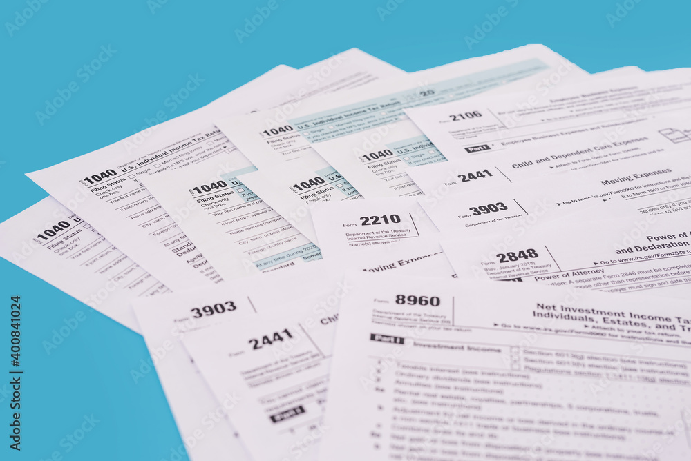 Fototapeta premium Tax concept. Many different usa tax form. 1040 form for fill in April.
