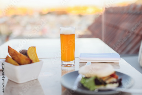 A glass of  beer with fried potatoes on a rooftop terrace