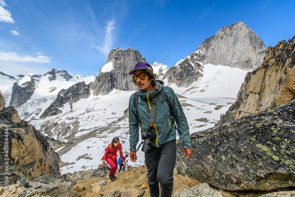 Climber taking photograph at Bugaboo Provincial Park, British Columbia, Canada Climber taking photograph at Bugaboo Provincial Park, British Columbia, Canada